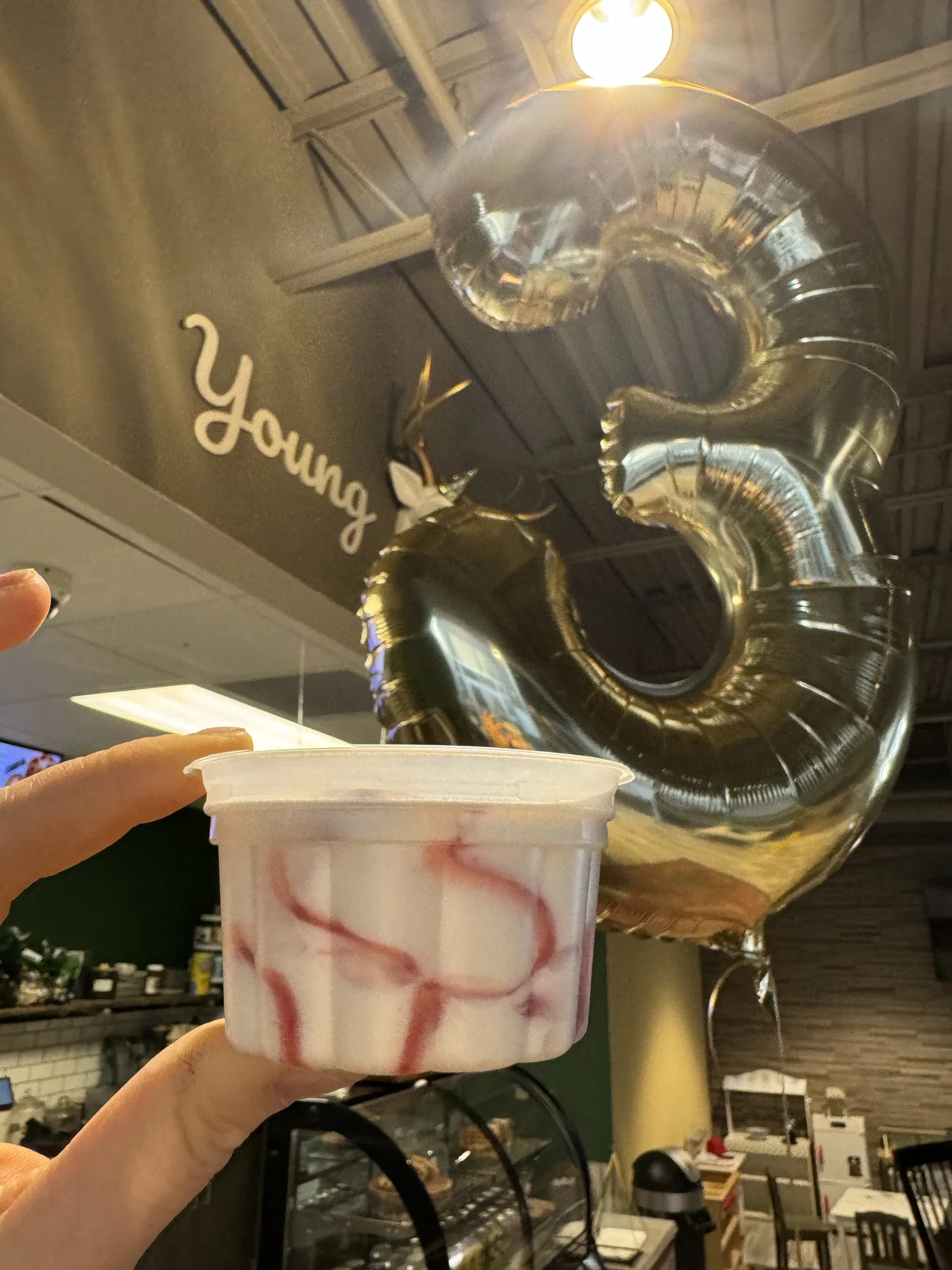 Special drink beside a number three balloon