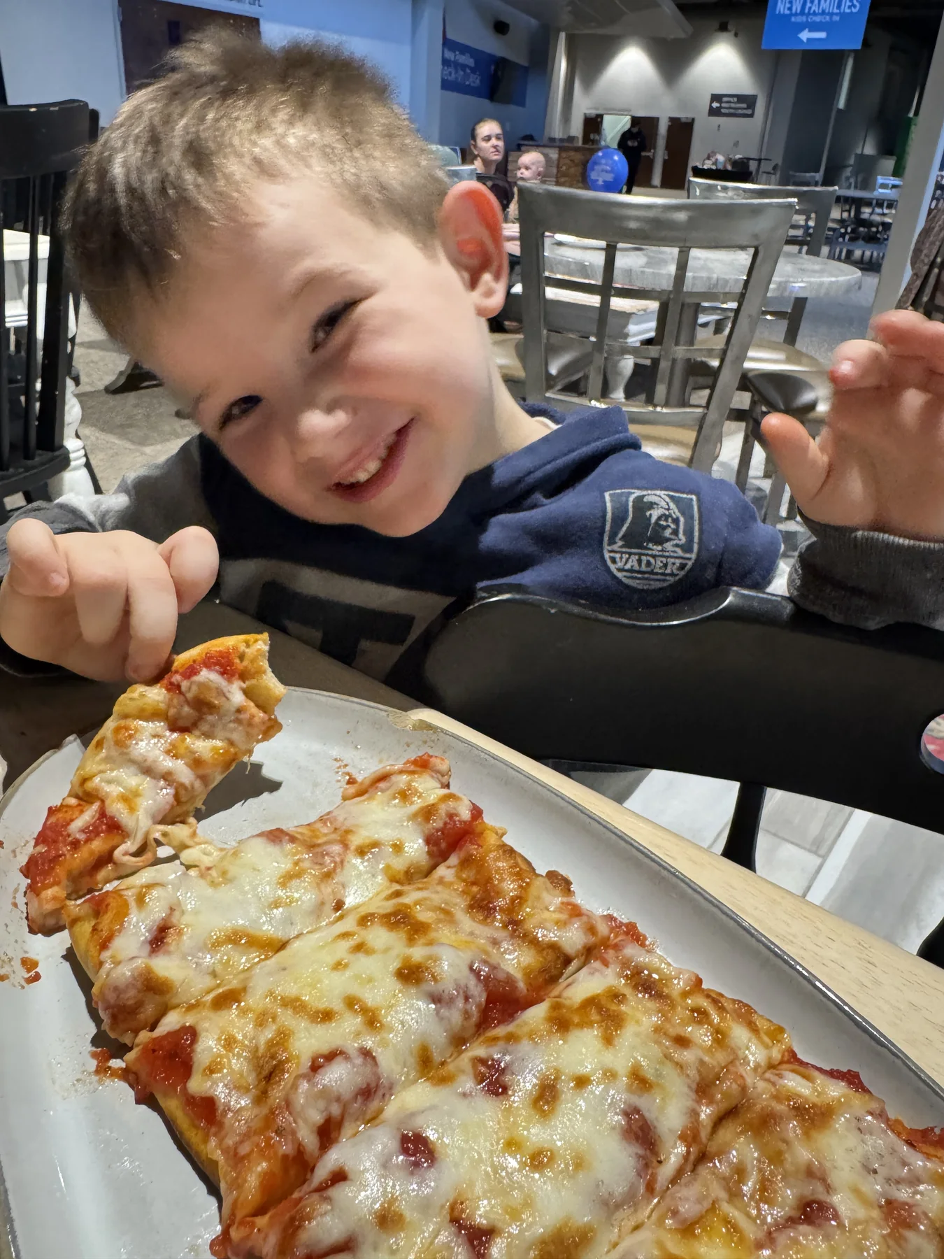 Child enjoying a flatbread at Young Bucks