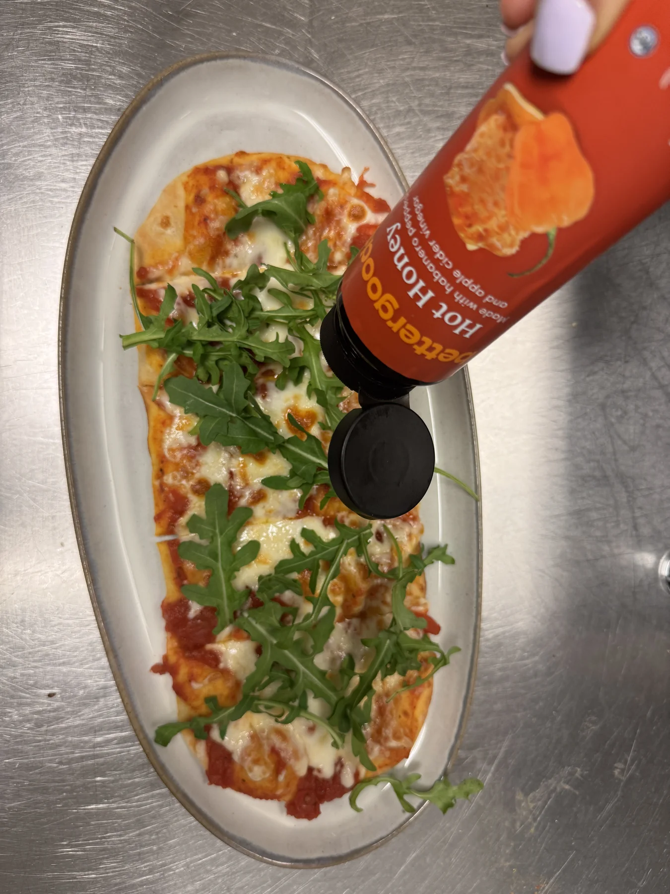 Hot honey flatbread being finished